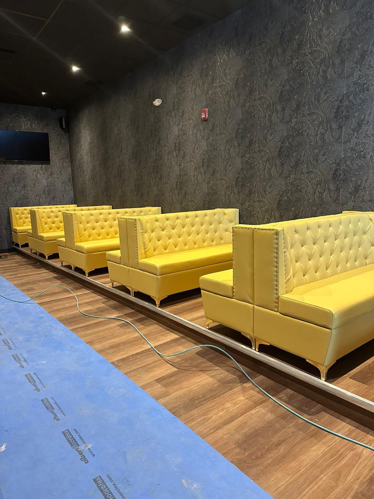 Commercial restaurant booth seating with golden yellow upholstery